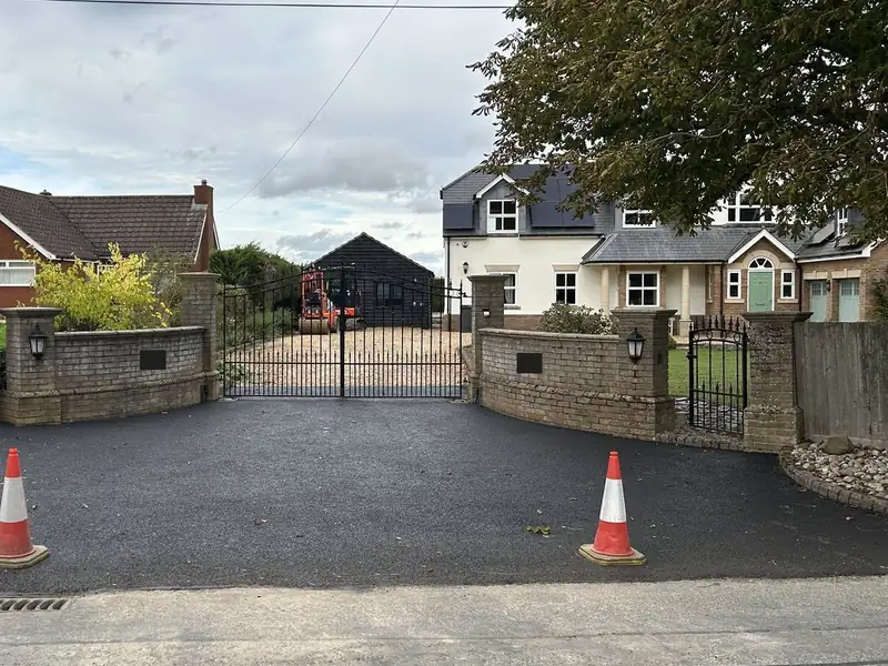 The same view of the driveway after the new tarmac surface was laid
